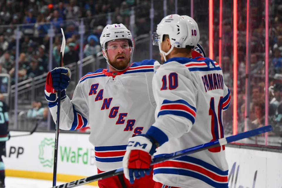 New York Rangers left wing Alexis Lafreniere (13) and left wing Artemi Panarin (10) celebrate after Panarin scored a goal against the Seattle Kraken during the first period at Climate Pledge Arena.Steven Bisig-Imagn Images