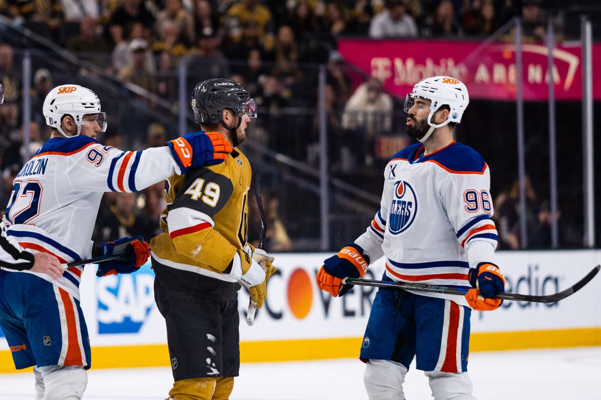 Las Vegas Golden Knights center Ivan Barbashev (49) and Edmonton Oilers defenseman Jake Walman (96) trash talk to one another during a NHL playoff game between the Las Vegas Golden Knights and the Edmonton Oilers, Wednesday May 14, 2025 in Las Vegas, Nev.