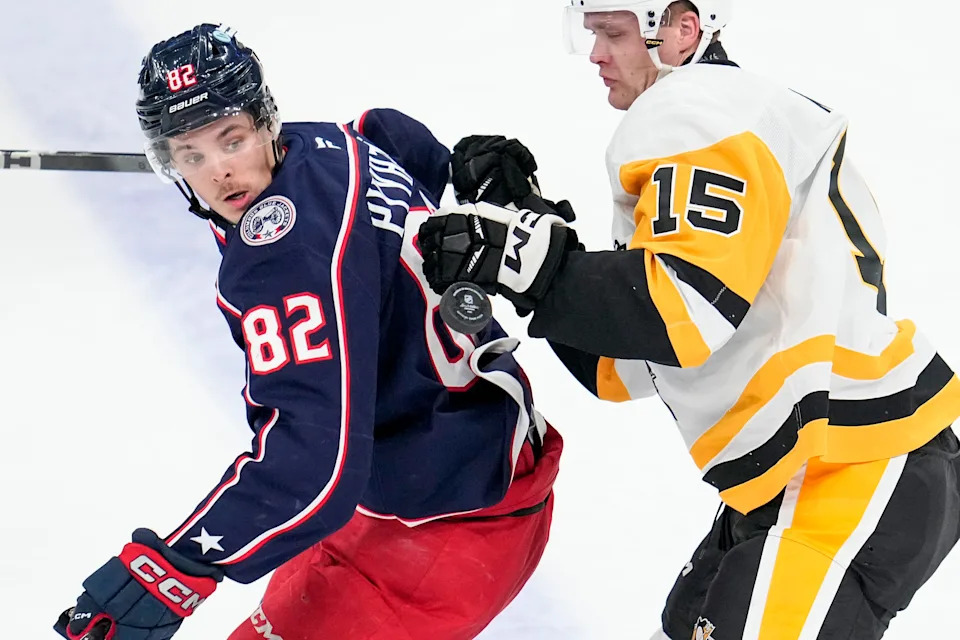 Oct 3, 2024; Columbus, Ohio, USA; Columbus Blue Jackets left wing Mikael Pyyhtia (82) watches the puck against Pittsburgh Penguins left wing Joona Koppanen (15) in the second period at Nationwide Arena.