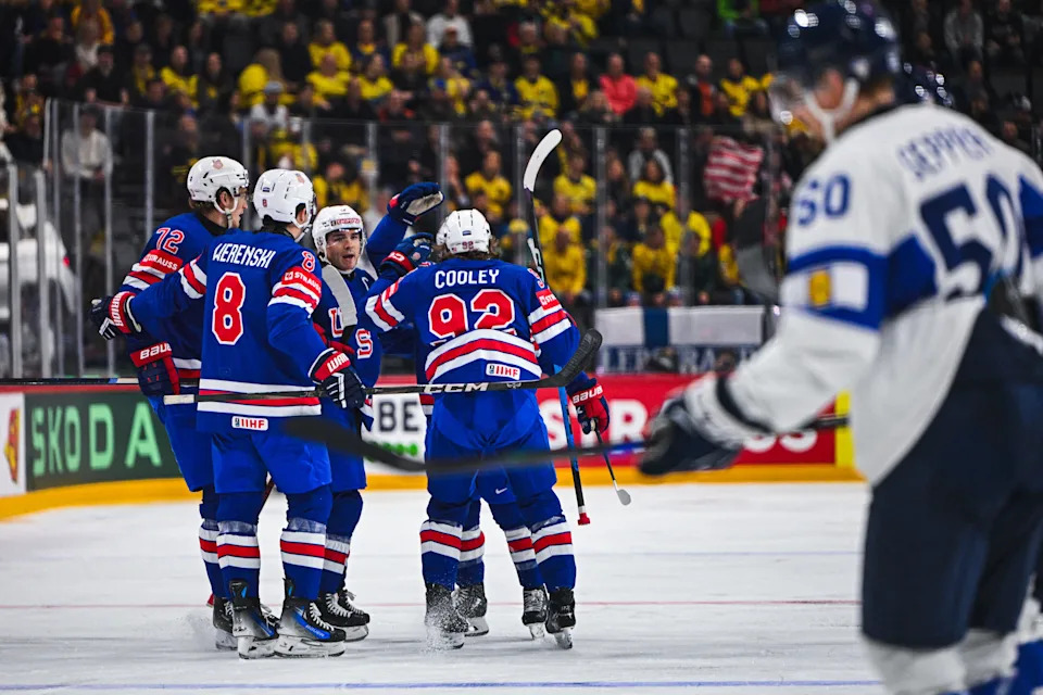 USA's forward #83 Conor Garland (covered) celebrates with teammates after scoring 1-0 during the IIHF Men's Ice Hockey World Championship quarter-final match between USA and Finland in Stockholm, on May 22, 2025. (Photo by Jonathan NACKSTRAND / AFP) (Photo by JONATHAN NACKSTRAND/AFP via Getty Images)