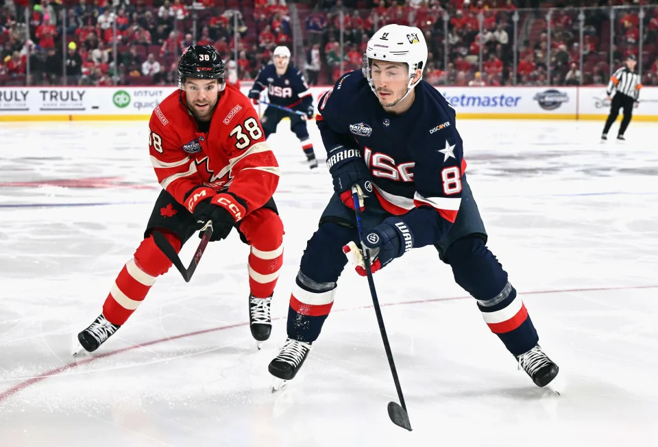 MONTREAL, CANADA - FEBRUARY 15: Brandon Hagel #38 of Team Canada checks Zach Werenski #8 of Team USA during the second period in the 4 Nations Face-Off game at the Bell Centre on February 15, 2025 in Montreal, Quebec, Canada. (Photo by Minas Panagiotakis/Getty Images)
