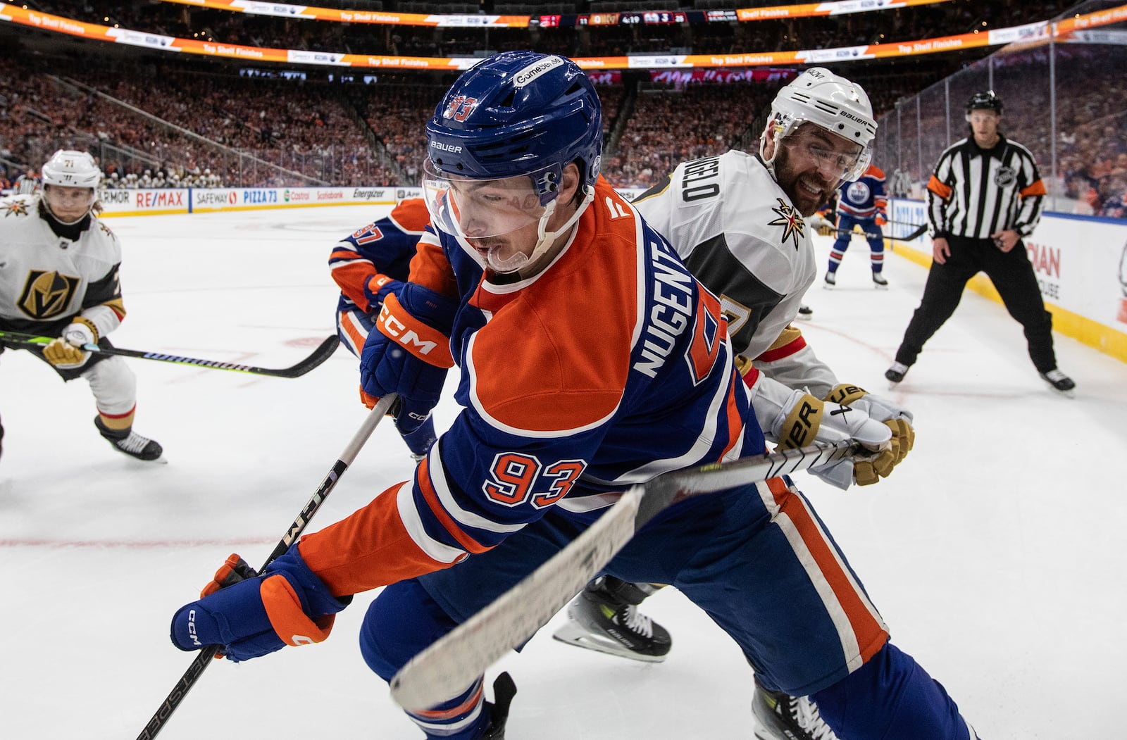 Vegas Golden Knights' Alex Pietrangelo, front right, and Edmonton Oilers' Ryan Nugent-Hopkins (93) battle for the puck during the second period of Game 4 of a second-round NHL hockey playoff series in Edmonton, Alberta, Monday, May 12, 2025. (Jason Franson/The Canadian Press via AP)