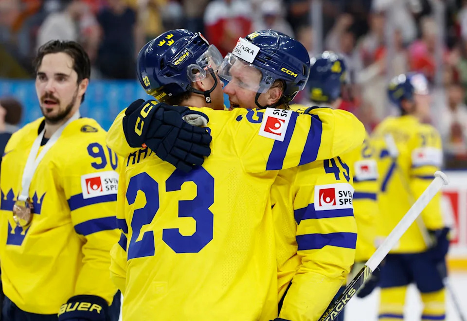 Sweden's Lucas Raymond, left, and Fabian Zetterlund celebrate after winning the IIHF World Championships Bronze Medal Game over Canada at Prague Arena in Prague, Czech Republic, Sunday, May 26, 2024.