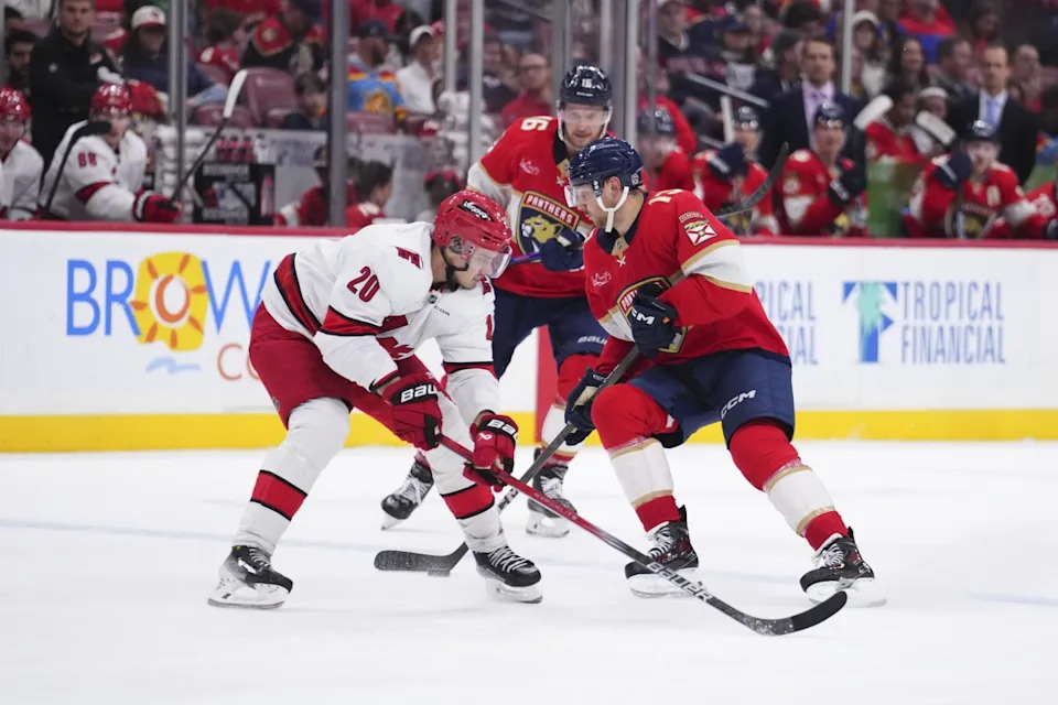 Florida Panthers center Sam Reinhart (13) controls the puck against Carolina Hurricanes center Sebastian Aho (20) during the third period at Amerant Bank Arena.Rich Storry-Imagn Images