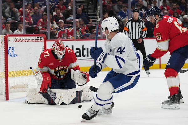 Florida Panthers goaltender Sergei Bobrovsky (72) defends the goal against Toronto Maple Leafs defenseman Morgan Rielly (44) during the first period of an NHL hockey game, Tuesday, April 8, 2025, in Sunrise, Fla. (AP Photo/Lynne Sladky)