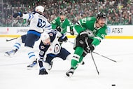 Dallas Stars left wing Mason Marchment (27) moves the puck past Winnipeg Jets center Mason...