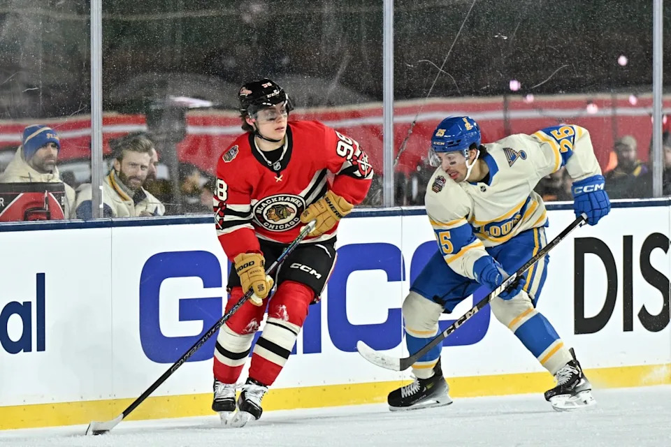 Chicago Blackhawks center Connor Bedard (98) skates with the puck against St. Louis Blues center Jordan Kyrou (25) during the third period in the Winter Classic at Wrigley Field. Daniel Bartel-Imagn Images