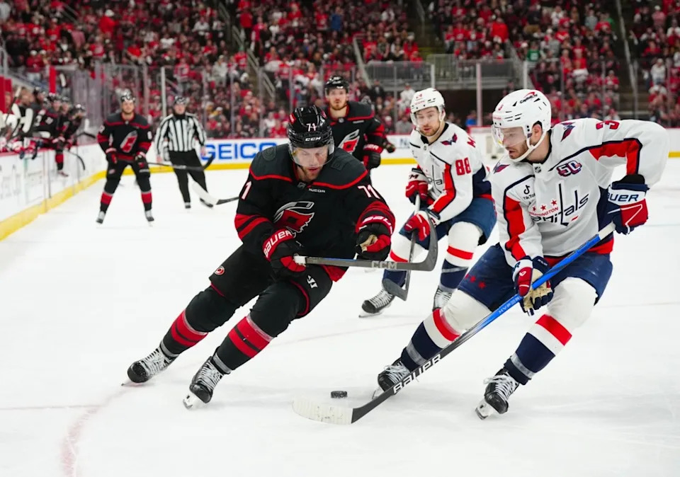 Carolina Hurricanes left wing Taylor Hall (71) and Washington Capitals defenseman Matt Roy (3) chase after the puck during the third period in game four of the second round of the 2025 Stanley Cup Playoffs.James Guillory-Imagn Images
