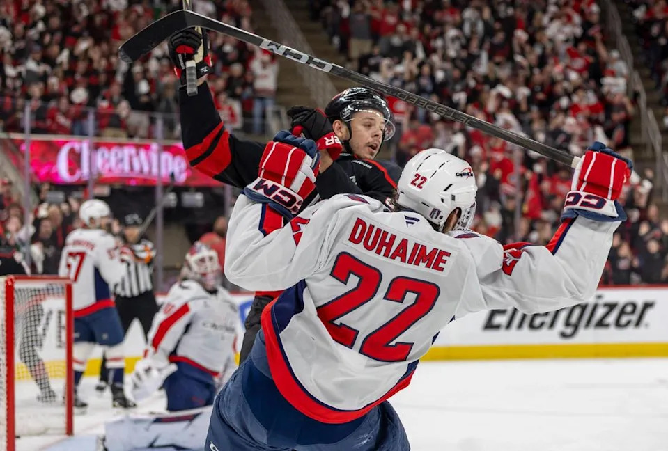 Carolina Hurricanes center Jesperi Kotkaniemi (82) checks Washington Capitals right wing Brandon Duhaime (22) in the first period during Game 4 of their series on Monday, May 12, 2025 at Lenovo Center in Raleigh, N.C.