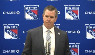Mike Sullivan takes a shot Peter Laviolette during his first press conference with the New York Rang