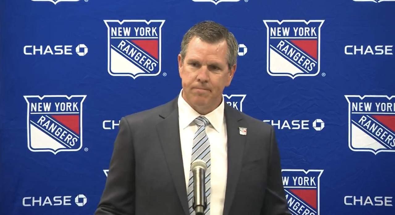 Mike Sullivan takes a shot Peter Laviolette during his first press conference with the New York Rang