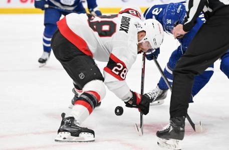 Ottawa Senators forward Claude Giroux winning a face-off against Toronto Maple Leafs forward Auston Matthews.