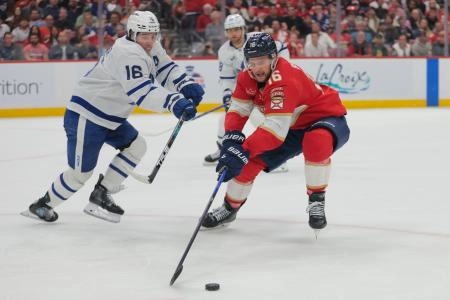 Toronto Maple Leafs forward Mitch Marner defending Florida Panthers forward Aleksander Barkov.