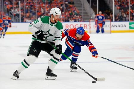 Edmonton Oilers forward Connor Brown forcing a play on Dallas Stars defenseman Thomas Harley.