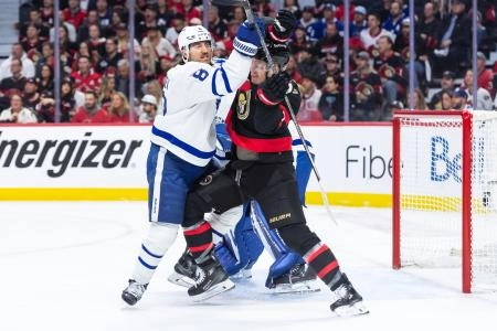 Toronto Maple Leafs defenseman Chris Tanev and Ottawa Senators forward Brady Tkachuk battling for position in front of the net. Toronto Maple Leafs defenseman Chris Tanev and Ottawa Senators forward Brady Tkachuk battling for position in front of the net.