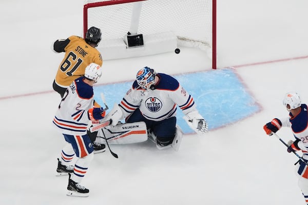 Vegas Golden Knights right wing Mark Stone (61) scores against Edmonton Oilers goaltender Calvin Pickard (30) during the first period of Game 1 of a second-round NHL hockey playoff series Tuesday, May 6, 2025, in Las Vegas. (AP Photo/John Locher)
