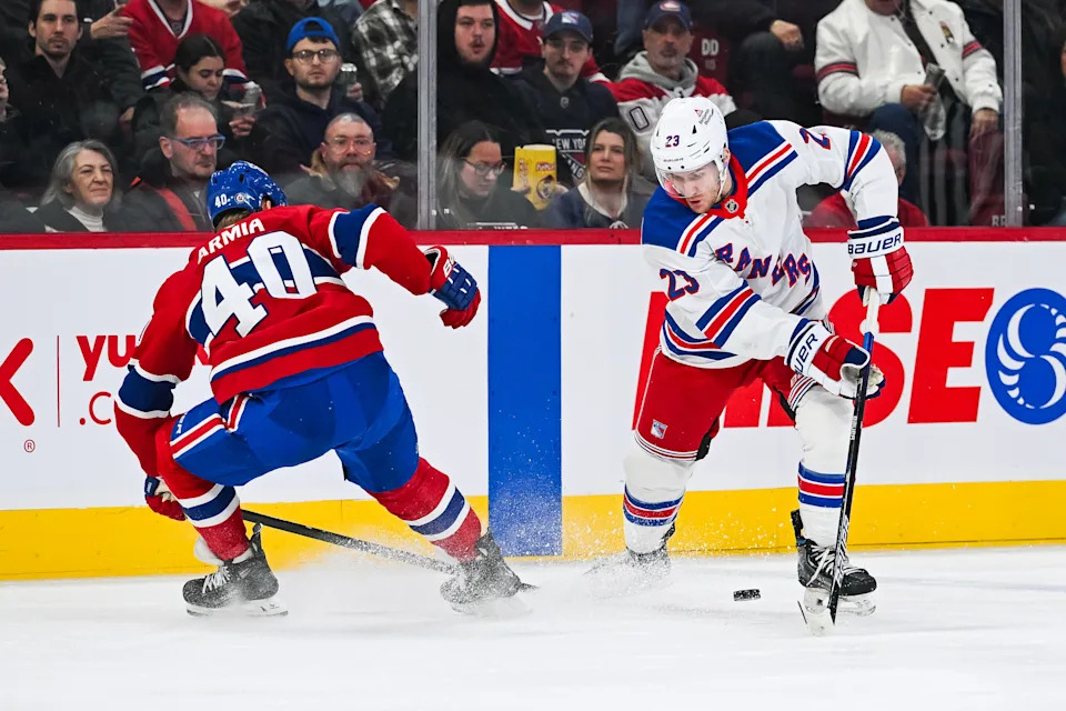Jan 19, 2025; Montreal, Quebec, CAN; New York Rangers defenseman Adam Fox (23) plays the puck against Montreal Canadiens right wing Joel Armia (40) during the first period at Bell Centre.