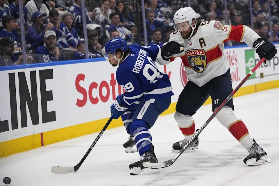 Florida Panthers defenseman Aaron Ekblad (5) goes to check Toronto Maple Leafs forward Nicholas Robertson (89) as he goes for the puck during the third period of game five of the second round.John E&period; Sokolowski-Imagn Images