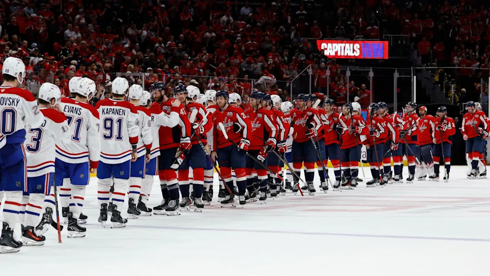 Washington Capitals and Montreal Canadiens players shake hands in the handshake line after game five at Capital One Arena.Geoff Burke-Imagn Images