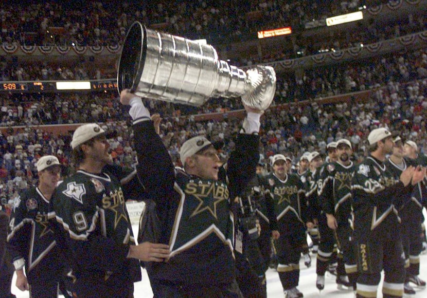 File photo: The Stars' Brett Hull celebrates with the Stanley Cup after the third OT of Game...