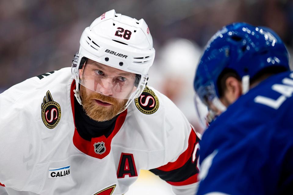 Ottawa Senators right-winger Claude Giroux and Toronto Maple Leafs left-winger Scott Laughton  face off during first period NHL hockey action in Toronto on Saturday, March 15, 2025.