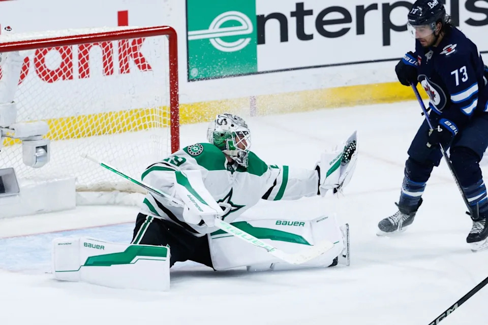 Dallas Stars goalie Jake Oettinger (29) makes a save as Winnipeg Jets forward Brandon Tanev (73) looks for a rebound during the third period in game five of the second round of the 2025 Stanley Cup Playoffs.Terrence Lee-Imagn Images