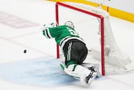 Dallas Stars goaltender Jake Oettinger makes a sprawling save during the third period in...