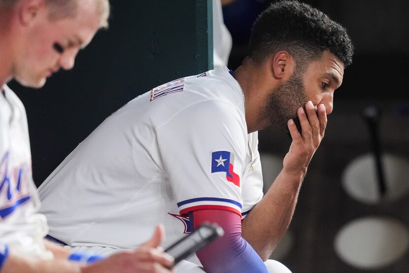 Texas Rangers second baseman Marcus Semien sits in the dugout during the fourth inning of...