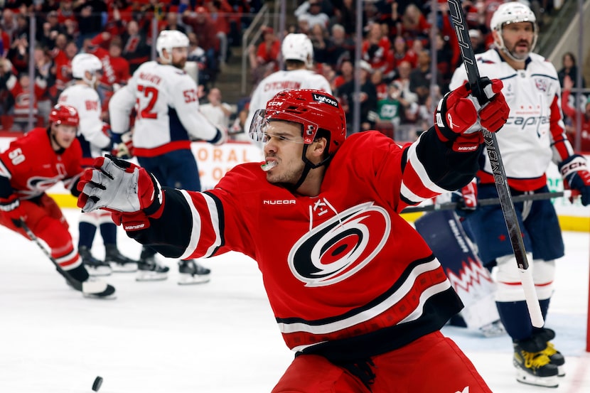 Carolina Hurricanes' Logan Stankoven (22) celebrates his goal with Washington Capitals' Alex...
