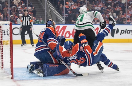Dallas Stars' Mason Marchment (27) trips up Edmonton Oilers' John Klingberg (36) as goalie...