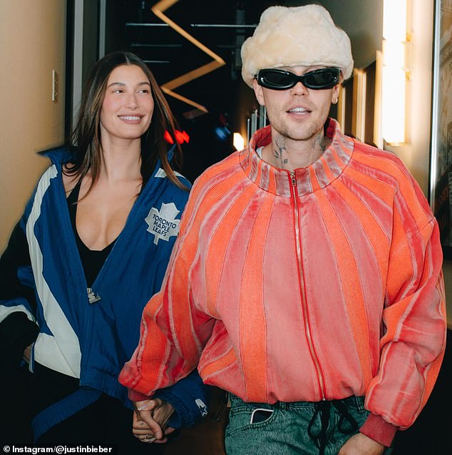 Justin and Hailey sweetly held hands, and the model gazed lovingly at her husband