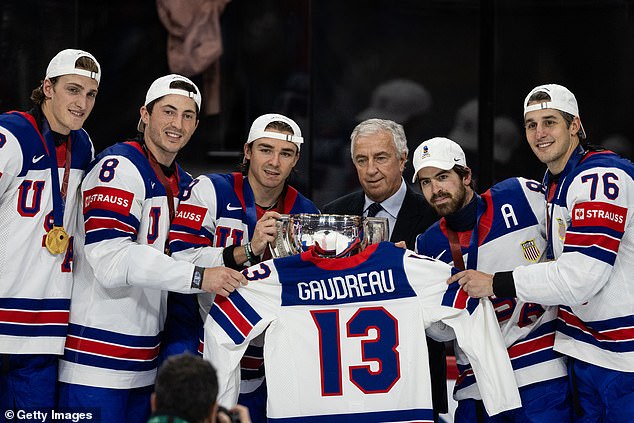 USA Hockey players hold up a jersey with Johnny Gaudreau's name and number on the back after winning the IIHF World Championship gold medal over Switzerland in Sweden
