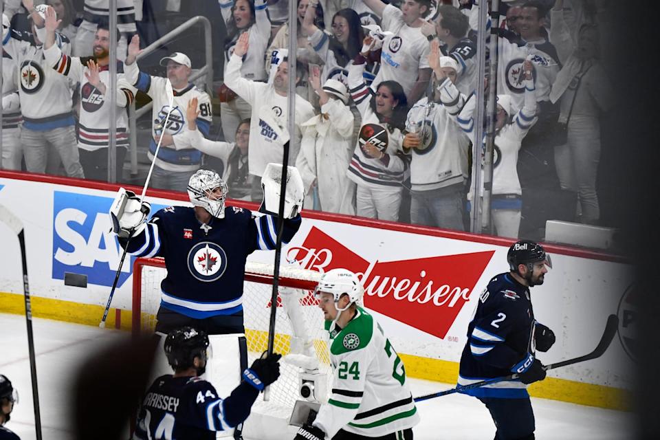 Winnipeg Jets goaltender Connor Hellebuyck (37) celebrates after an empty-net goal by Nikolaj Ehlers on the Dallas Stars during third period NHL playoff hockey action in Winnipeg, Friday, May 9, 2025.