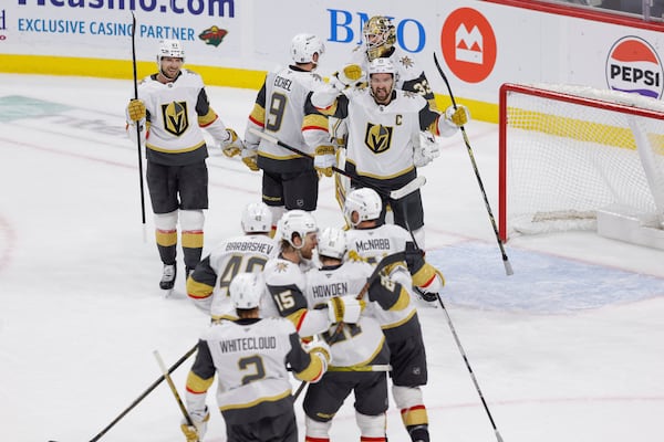 Vegas Golden Knights celebrate after winning Game 6 of a first-round NHL hockey playoff series against the Minnesota Wild, Thursday, May 1, 2025, in St. Paul, Minn. (AP Photo/Bailey Hillesheim)