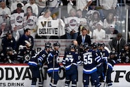Winnipeg Jets head coach Scott Arniel talks with players during a timeout against the Dallas...