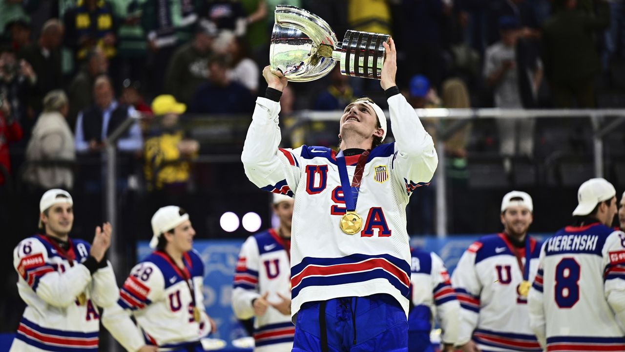 USA's Tage Thompson, who scored the only goal during overtime, holds the trophy after the Hockey World Championship gold medal match between Switzerland and USA at Avicii Arena in Stockholm, Sweden, Sunday May 25, 2025. (Magnus Lejhall/Keystone via AP)