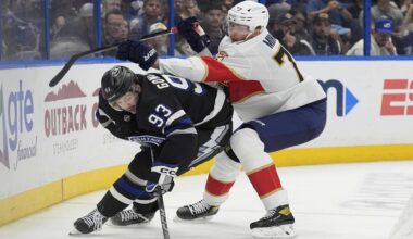 Tampa Bay center Gage Goncalves (93) battles for a puck with Florida’s Niko Mikkola (77) during the Lightning’s 5-1 win Tuesday, April 15 in Tampa. (AP Photo/Chris O’Meara)