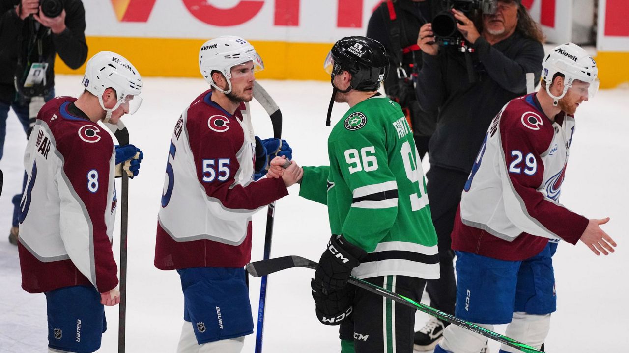 Colorado Avalanche's Cale Makar (8), Ryan Lindgren (55) Dallas Stars' Mikko Rantanen (96) and Nathan MacKinnon (29) exchange handshakes after the Stars 4-2 win in Game 7 of a first-round NHL hockey playoff series Saturday, May 3, 2025, in Dallas. (AP Photo/Julio Cortez)