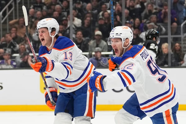 Edmonton Oilers center Mattias Janmark, left, celebrates his goal with right wing Vasily Podkolzin during the third period in Game 5 of an NHL hockey first-round playoff series against the Los Angeles Kings, Tuesday, April 29, 2025, in Los Angeles. (AP Photo/Mark J. Terrill)