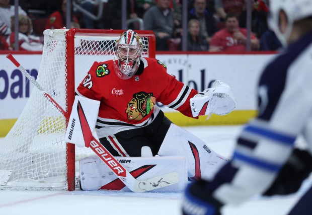 Blackhawks goaltender Spencer Knight keeps his eyes on the puck against the Jets on April 12, 2025, at the United Center. (Chris Sweda/Chicago Tribune)