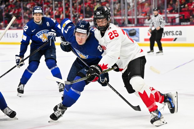 Julius Miettinen (27) of Team Finland and Matthew Schaefer (25) of Team Canada battle during the IIHF World Junior Championship on Dec. 26, 2024, in Ottawa, Ontario. (Minas Panagiotakis/Getty Images)