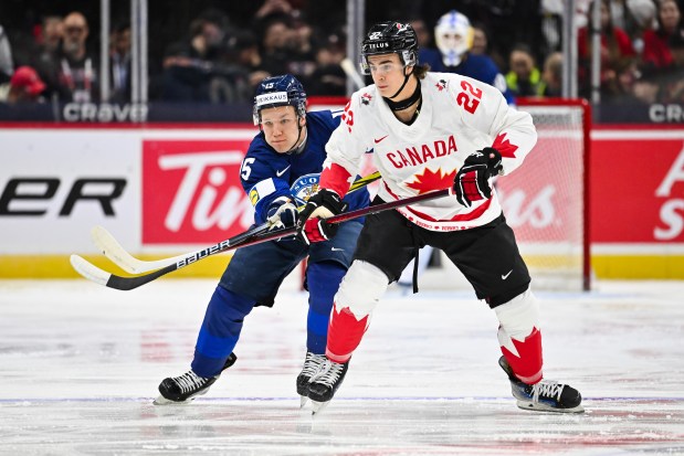 Tuomas Uronen of Team Finland and Porter Martone of Team Canada battle during the IIHF World Junior Championship on Dec. 26, 2024, in Ottawa, Ontario. (Minas Panagiotakis/Getty Images)