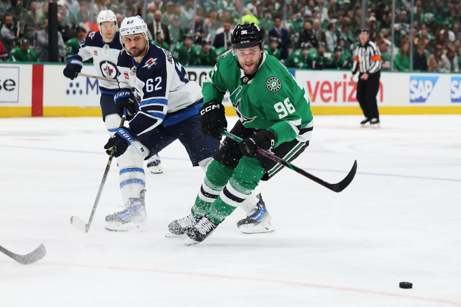 Dallas Stars right wing Mikko Rantanen (96) and Winnipeg Jets right wing Nino Niederreiter (62) compete for control of the puck in the first period of Game 4 of a second-round NHL hockey playoff series in Dallas, Tuesday, May 13, 2025. (AP Photo/Gareth Patterson)