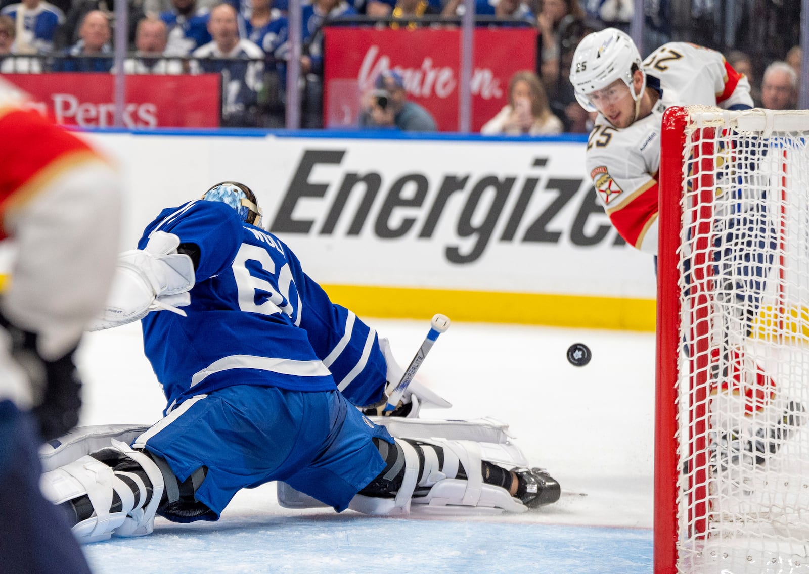 Toronto Maple Leafs goaltender Joseph Woll (60) makes a save on Florida Panthers' Mackie Samoskevich (25) during third period NHL playoff hockey action in Toronto on Wednesday, May 7, 2025. (Frank Gunn/The Canadian Press via AP)