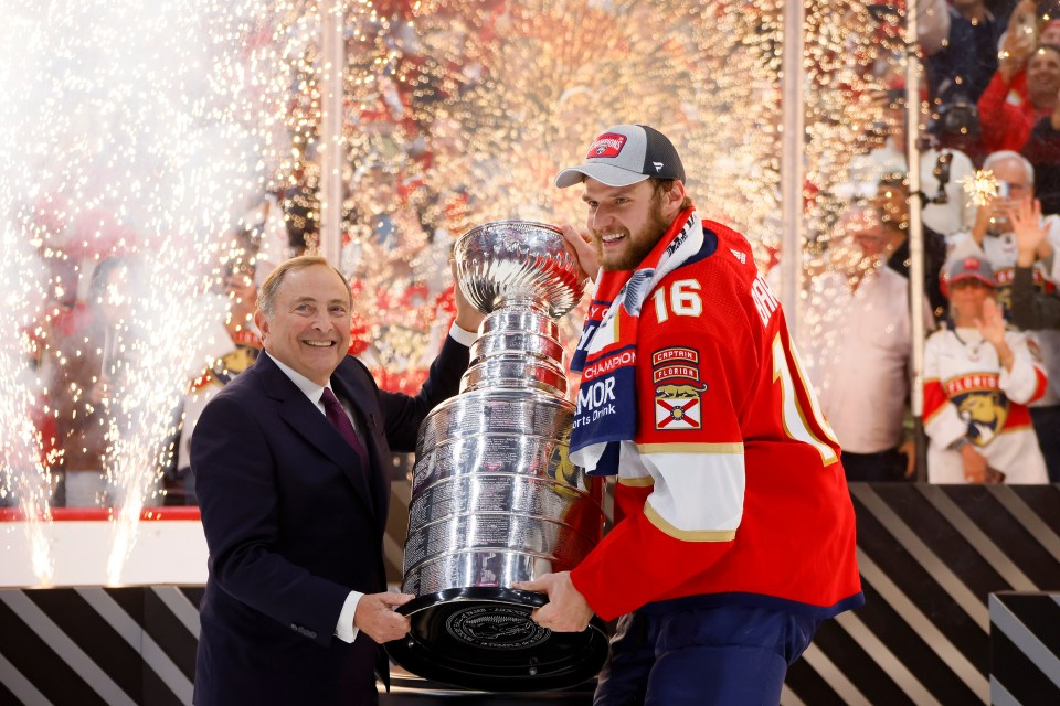 SUNRISE, FLORIDA - JUNE 24: NHL Commissioner Gary Bettman and Aleksander Barkov #16 of the Florida Panthers hold the Stanley Cup after Florida's 2-1 victory against the Edmonton Oilers in Game Seven of the 2024 Stanley Cup Final at Amerant Bank Arena on June 24, 2024 in Sunrise, Florida. (Photo by Bruce Bennett/Getty Images)