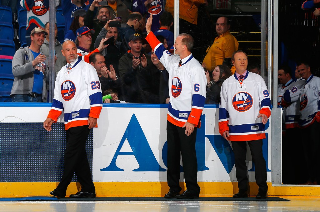 Former New York Islanders Bobby Nystrom (L), Ken Morrow (C), and Butch Goring are honored before a game between the New York Islanders and the Buffalo Sabres on April 4, 2015 at Nassau Veterans Memorial Coliseum in Uniondale, New York. 