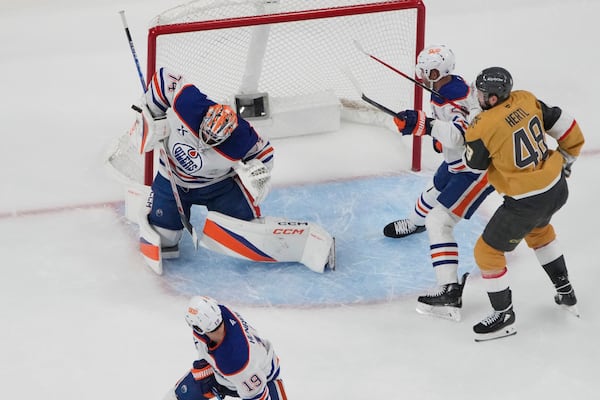 Edmonton Oilers goaltender Stuart Skinner (74) makes a save against the Vegas Golden Knights during the third period of Game 5 of a second-round NHL hockey playoff series Wednesday, May 14, 2025, in Las Vegas. (AP Photo/John Locher)