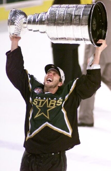 File photo: Mike Modano hoists the Stanley Cup after the Stars beat the Sabres in the 3rd OT...