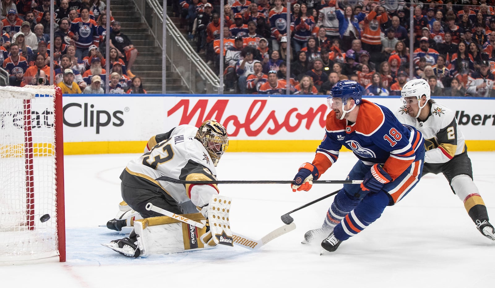 Vegas Golden Knights goalie Adin Hill (33) makes a save against Edmonton Oilers' Zach Hyman (18) as Golden Knights' Zach Whitecloud (2) defends during the second period of Game 4 of a second-round NHL hockey playoff series in Edmonton, Alberta, Monday, May 12, 2025. (Jason Franson/The Canadian Press via AP)