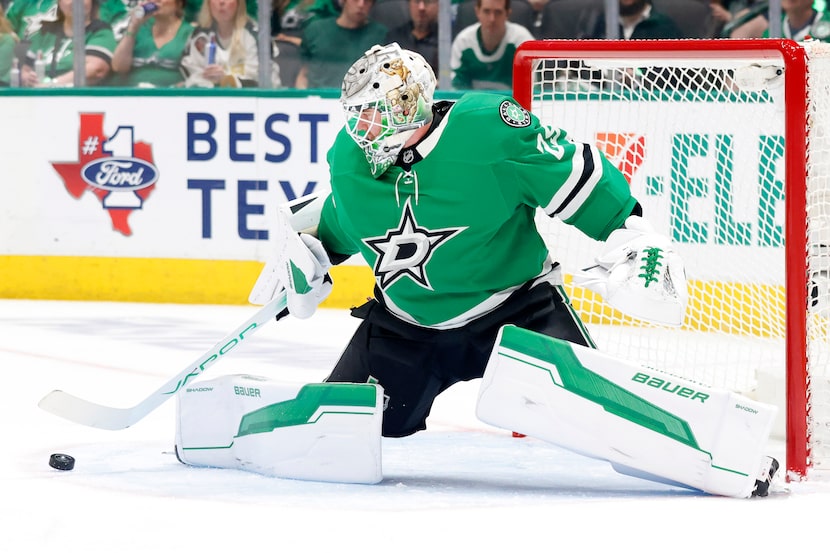 Dallas Stars goaltender Jake Oettinger (29) deflects a Colorado Avalanche shot during the...